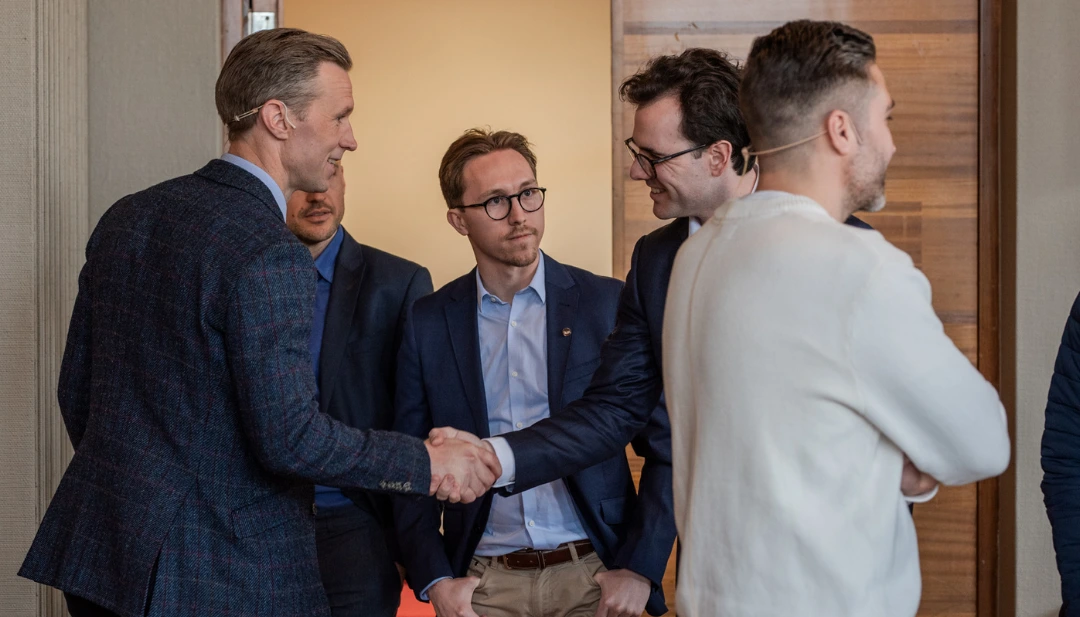 Two men shaking hands on a sustainability agreement